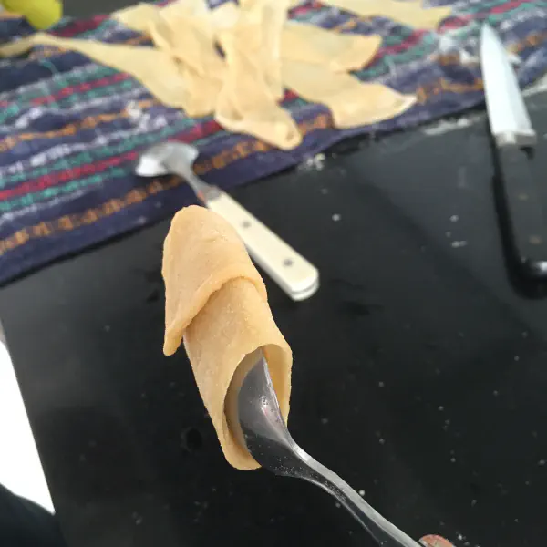Rolling the manicotti before frying