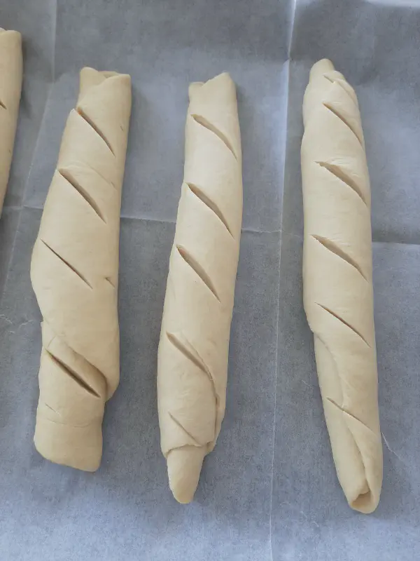 Homemade Italian bread in the oven - rolled